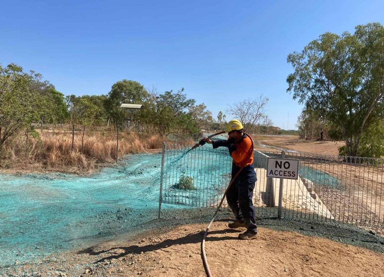 A Man in Orange Suit Hydro Mulching with Flexterra — Spray Grass in Northern Territory